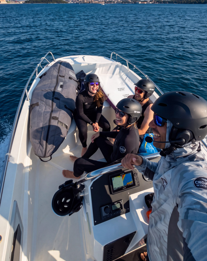 Kietsurf and Wing foil lessons in Pula Croatia. Students with instructor on the boat
